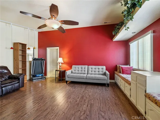 a bedroom with furniture and a large window