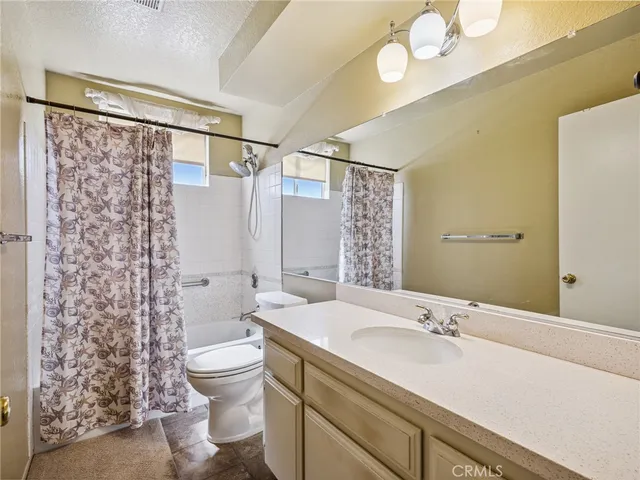 a bathroom with a double vanity sink toilet and shower