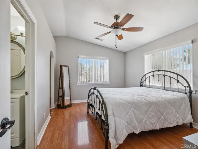 a bedroom with a bed and wooden floor