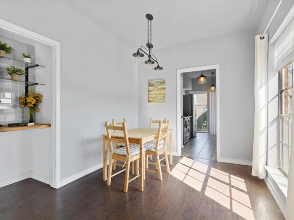 a view of a dining room with furniture window and wooden floor