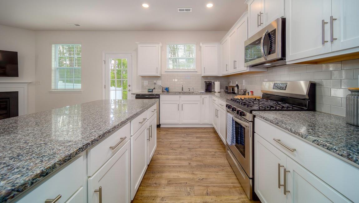 1205 Secrest Cmns Drive Monroe, NC 28112 - Photo 15 of 38 a large kitchen with stainless steel appliances granite countertop a stove a sink and a granite counter tops