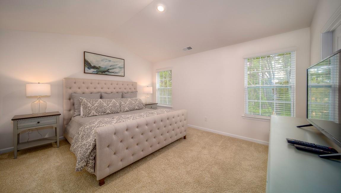 1205 Secrest Cmns Drive Monroe, NC 28112 - Photo 35 of 38 a bedroom with a bed and a couch next to a window