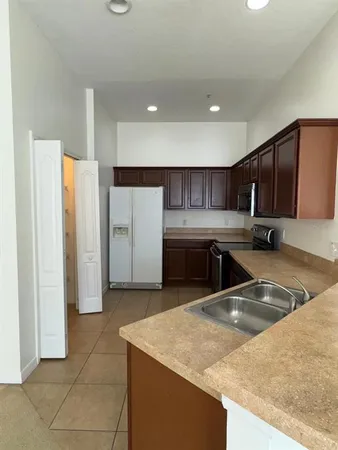 a kitchen with a sink a stove and refrigerator