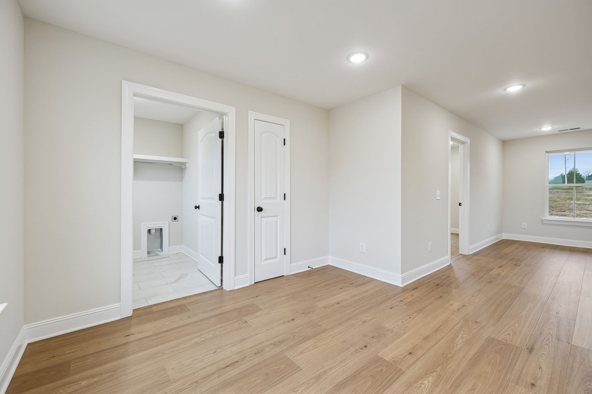 1035 Landing Lane Adams, TN 37010 - Photo 12 of 26 an empty room with wooden floor & cabinet and windows