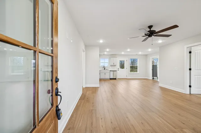 a view of a kitchen with a sink and wooden floor