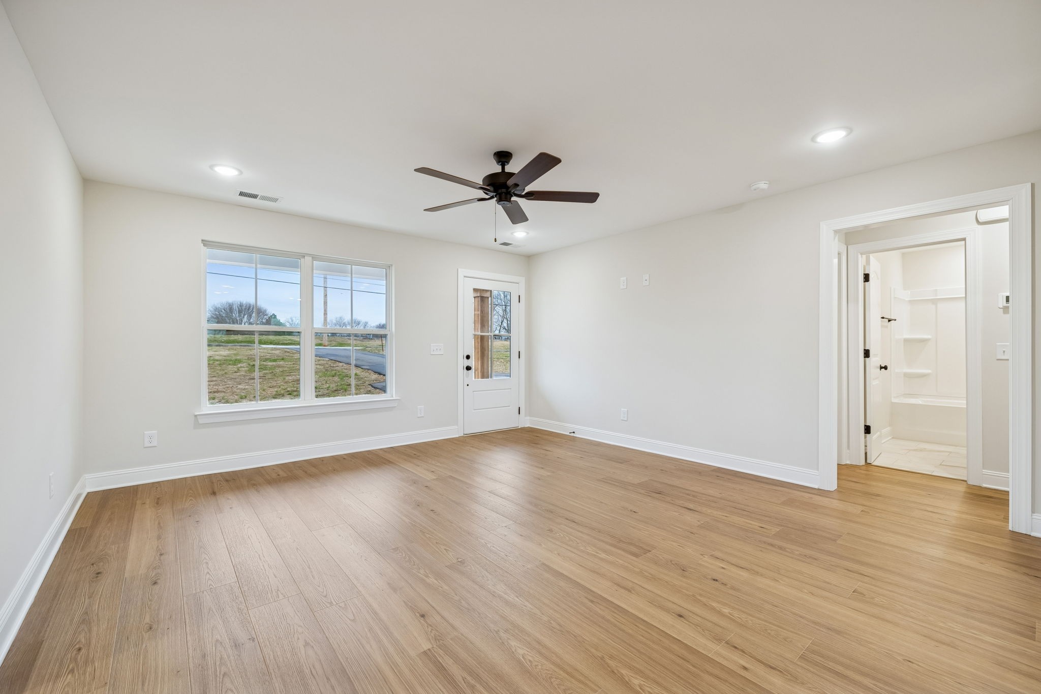 1035 Landing Lane Adams, TN 37010 - Photo 6 of 26 an empty room with wooden floor and windows