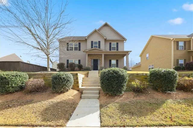 a front view of a house with a yard