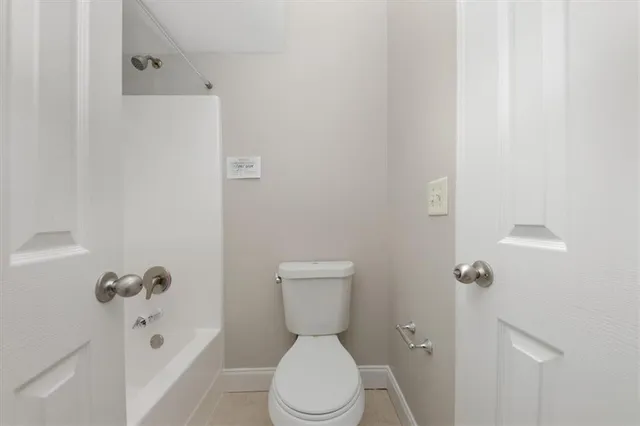 a white toilet sitting next to a bathroom sink