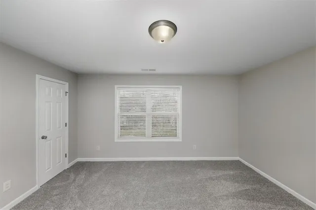 an empty room with windows and entrance