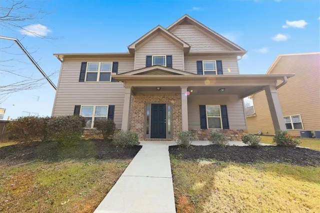 a front view of a house with a yard
