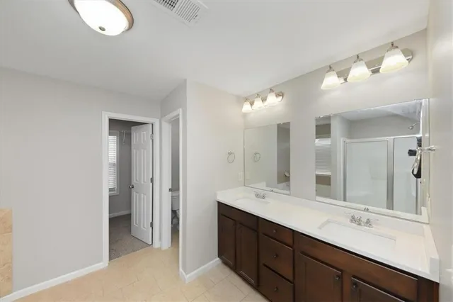 a bathroom with a double vanity sink and a mirror