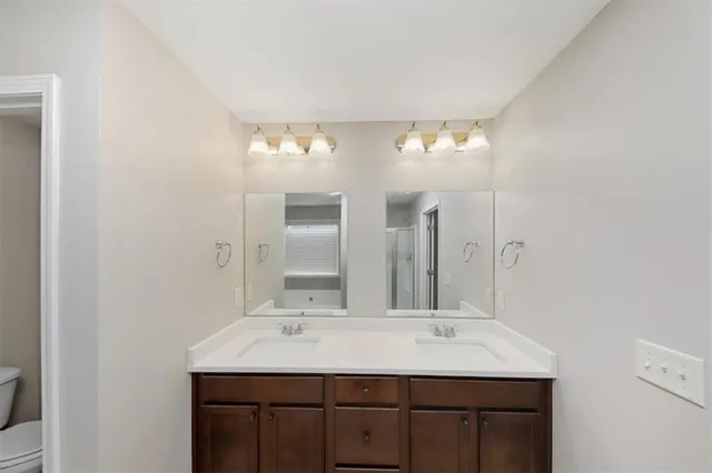 a bathroom with a double vanity sink and a mirror