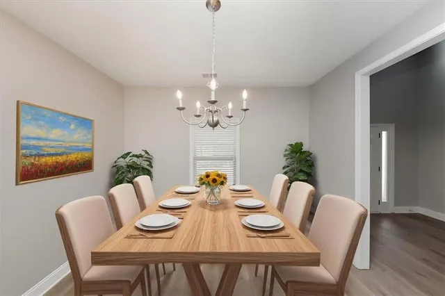 a view of a dining room with furniture wooden floor and a chandelier