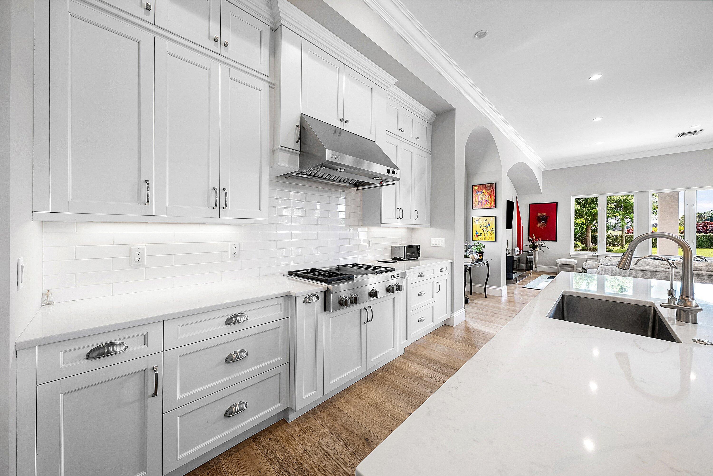 4600 Bocaire Boulevard Boca Raton, FL 33487 - Photo 19 of 98 a kitchen with stainless steel appliances granite countertop a lot of counter space and wooden floors