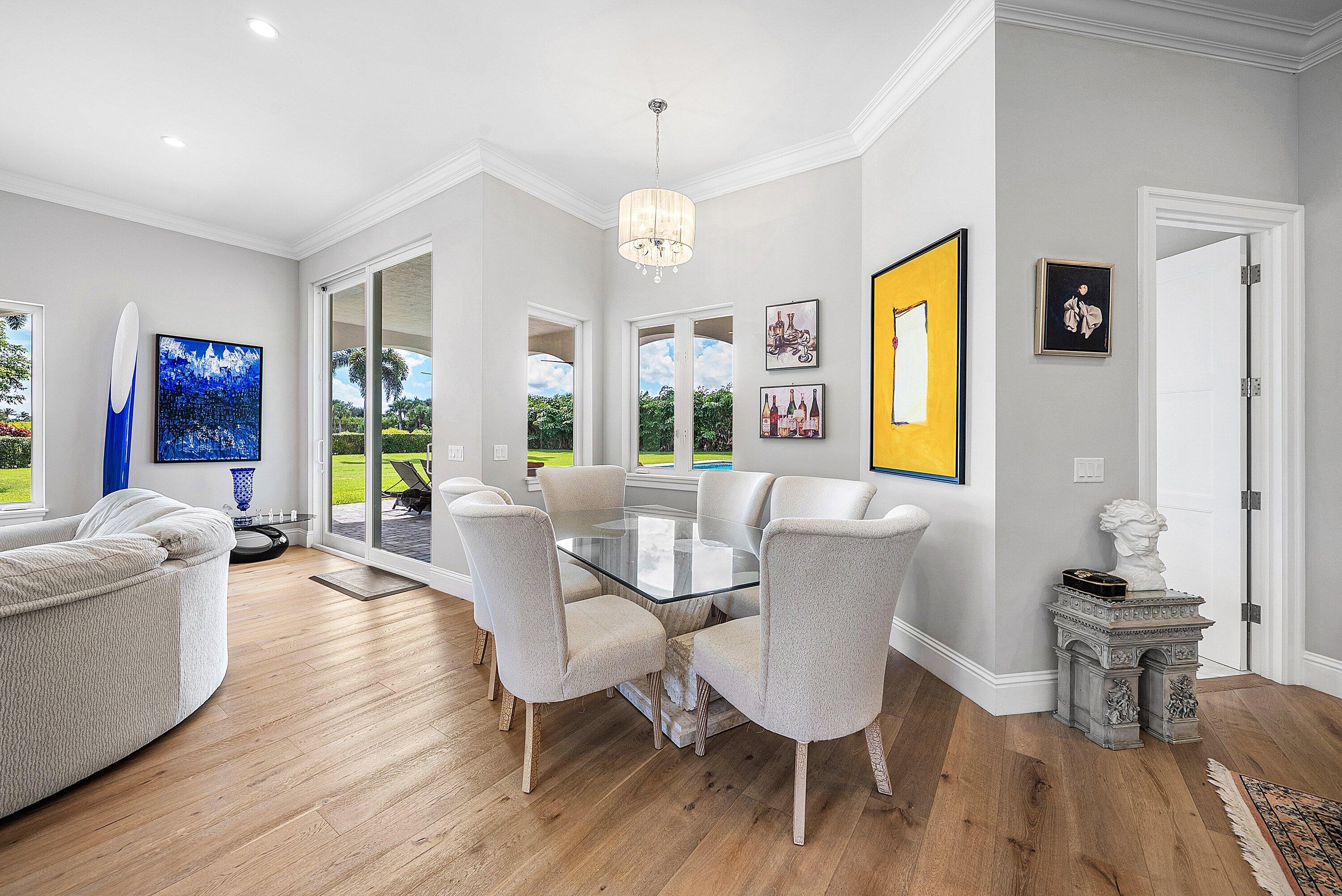 4600 Bocaire Boulevard Boca Raton, FL 33487 - Photo 24 of 98 a view of a dining room with furniture and a chandelier