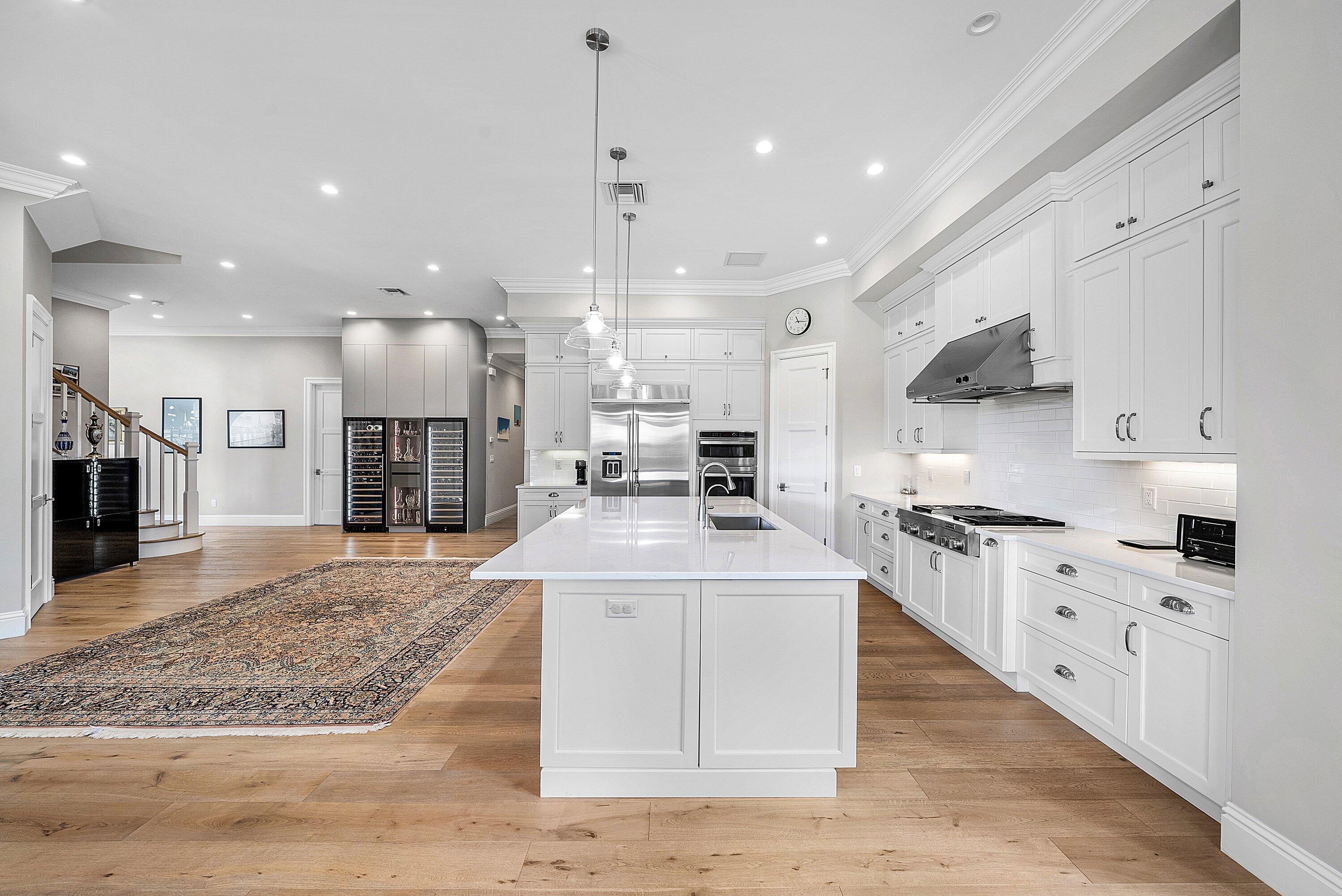 4600 Bocaire Boulevard Boca Raton, FL 33487 - Photo 31 of 98 a large kitchen with stainless steel appliances kitchen island granite countertop a sink and a stove
