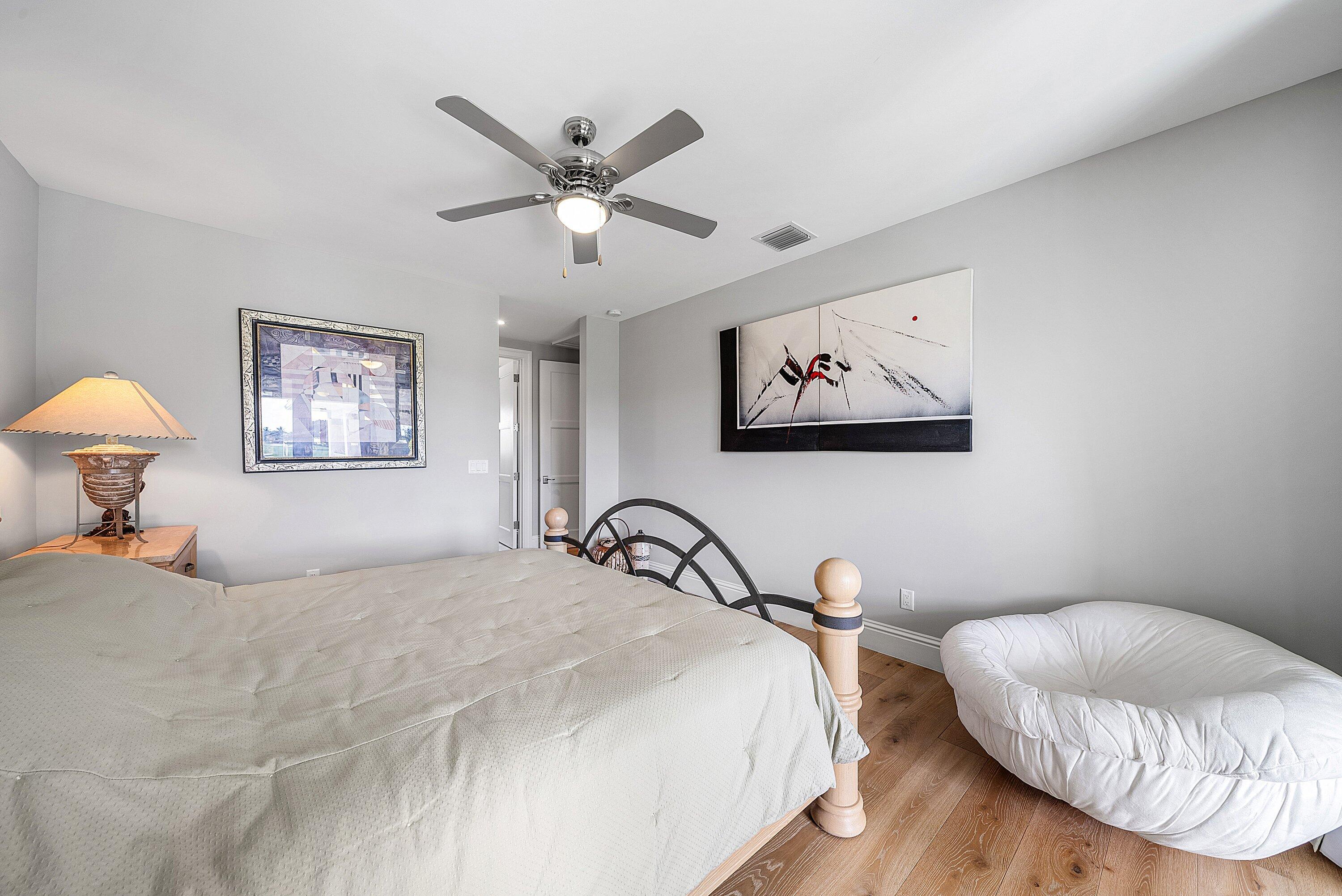 4600 Bocaire Boulevard Boca Raton, FL 33487 - Photo 42 of 98 a bedroom with a bed and a chandelier