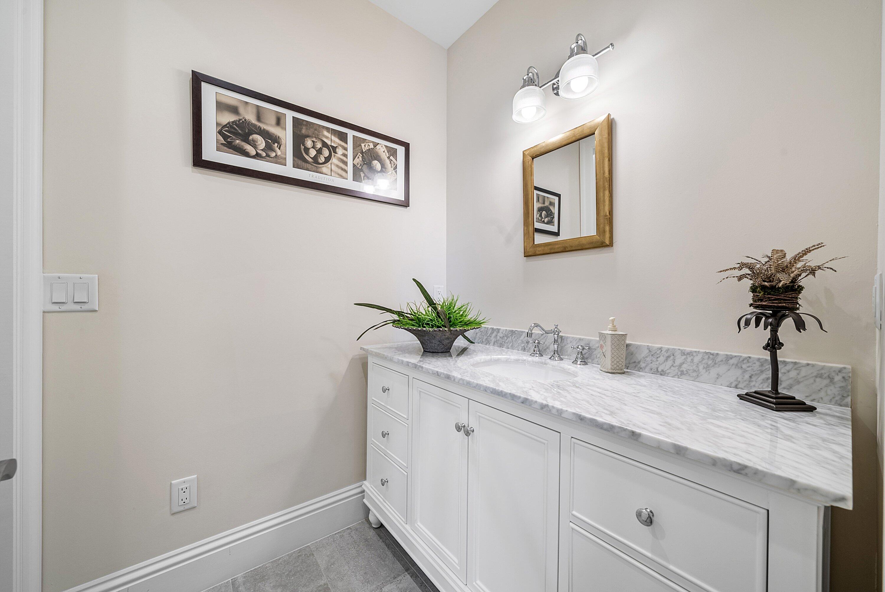 4600 Bocaire Boulevard Boca Raton, FL 33487 - Photo 48 of 98 a bathroom with a sink a vanity and mirror