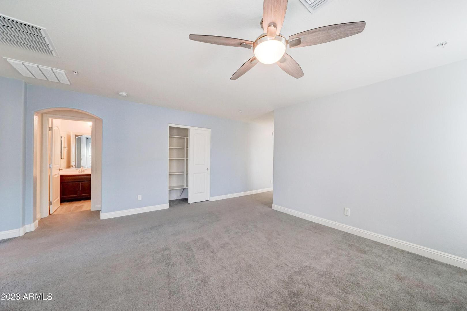 2297 North Alsap Road Buckeye, AZ 85396 - Photo 13 of 36 an empty room with chandelier fan