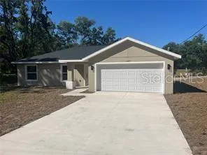 a view of a house with a yard and garage