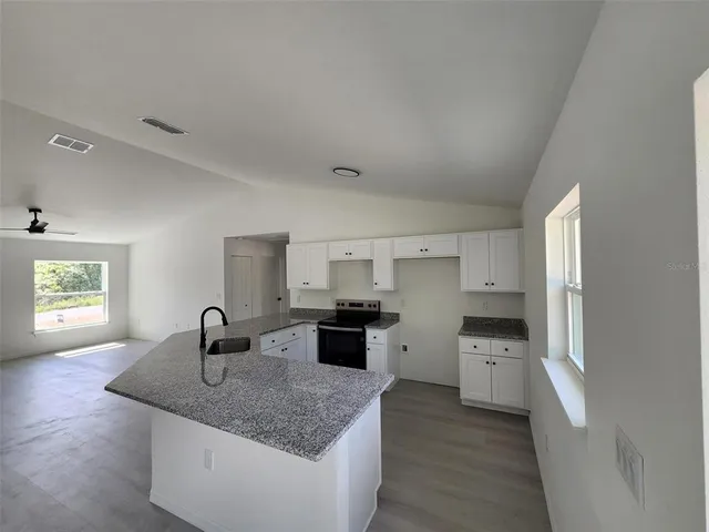 a kitchen with a stove a sink and a refrigerator