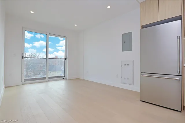 a view of an empty room with a fireplace
