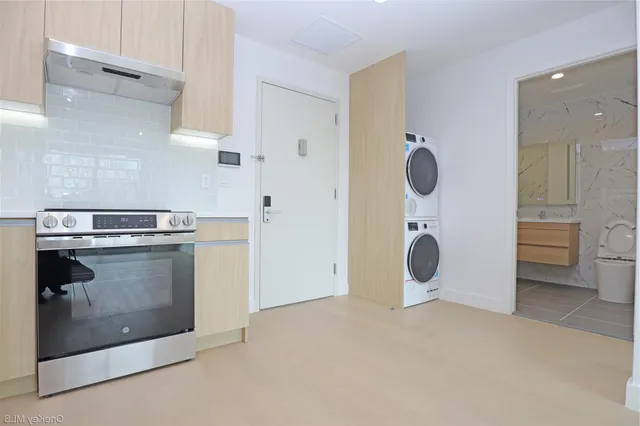 a kitchen with stainless steel appliances a refrigerator and a stove