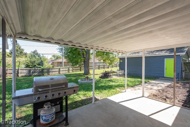 a backyard of a house with couch and outdoor seating
