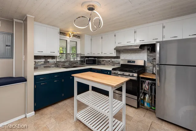 a kitchen with a refrigerator and a sink