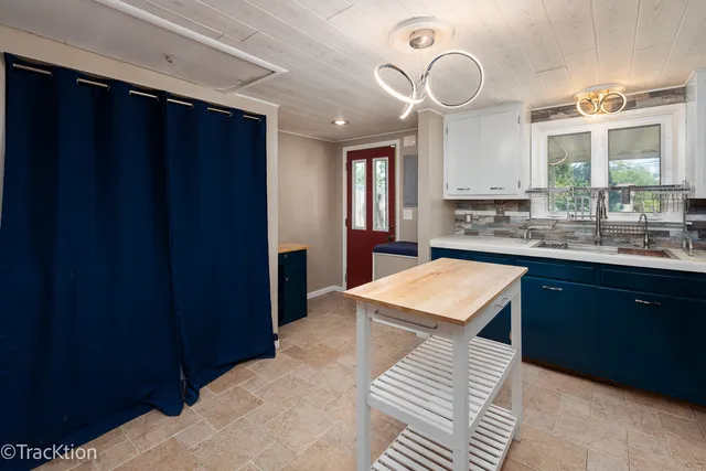 a kitchen with a sink a counter space and a window