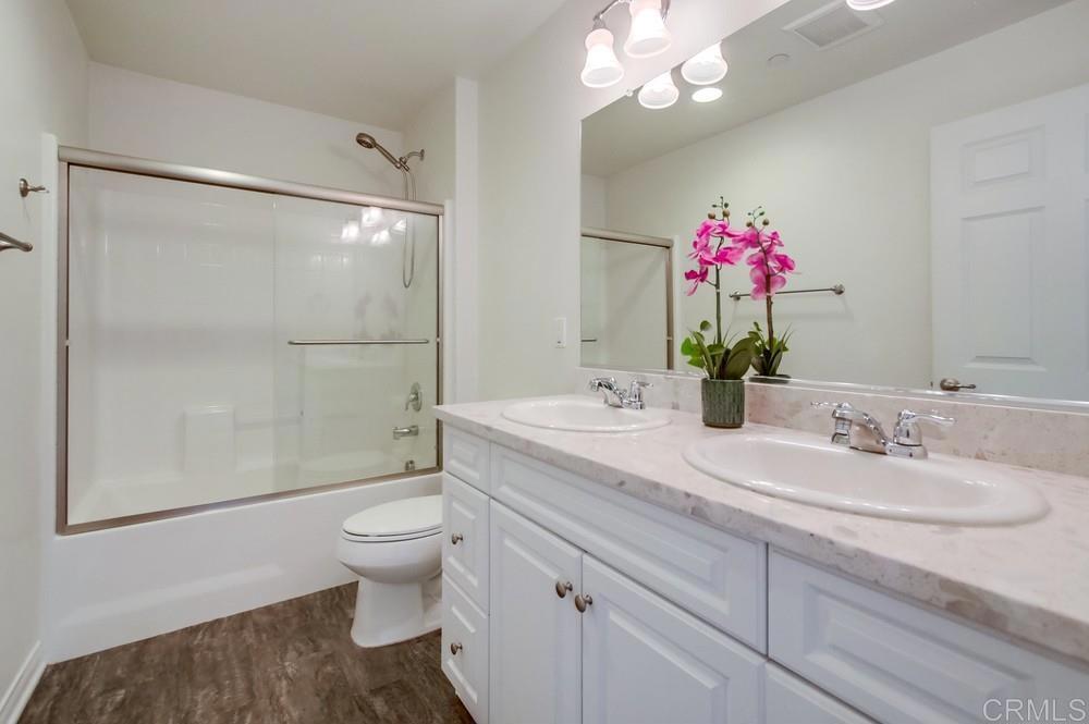 13109 Beacon View Lane El Cajon, CA 92021 - Photo 14 of 36 a bathroom with a granite countertop sink mirror and toilet