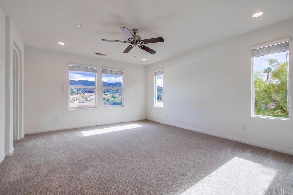 13109 Beacon View Lane El Cajon, CA 92021 - Photo 20 of 36 an empty room with windows and ceiling fan