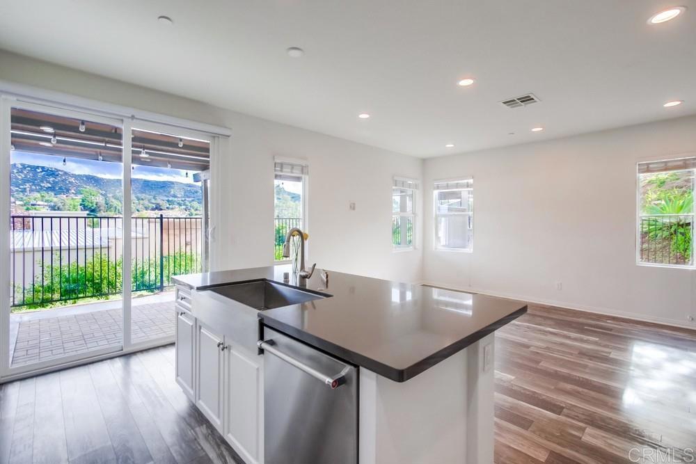 13109 Beacon View Lane El Cajon, CA 92021 - Photo 2 of 36 a kitchen with a table chairs and wooden floor