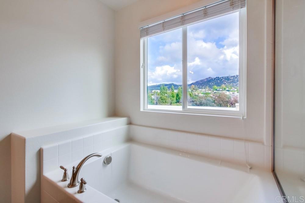 13109 Beacon View Lane El Cajon, CA 92021 - Photo 24 of 36 a bath tub sitting in a bathroom next to a window