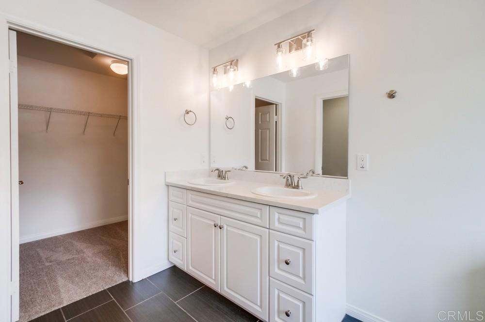 13109 Beacon View Lane El Cajon, CA 92021 - Photo 25 of 36 a bathroom with a double vanity sink and a mirror