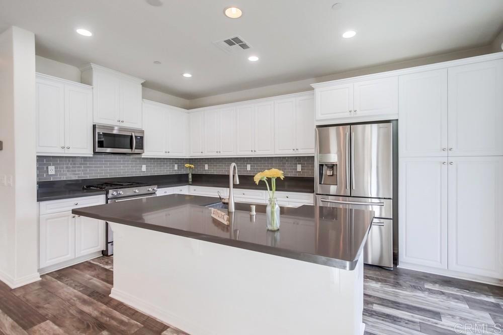 13109 Beacon View Lane El Cajon, CA 92021 - Photo 8 of 36 a kitchen with kitchen island a counter top space cabinets and stainless steel appliances