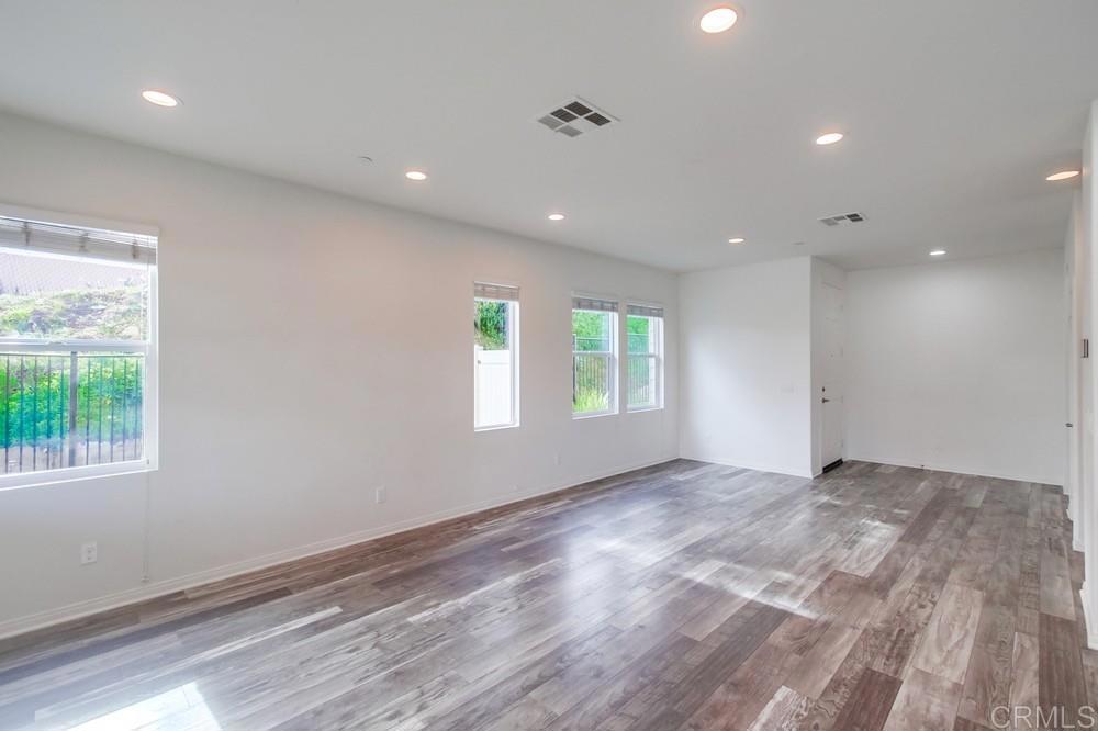 13109 Beacon View Lane El Cajon, CA 92021 - Photo 10 of 36 a view of an empty room with wooden floor and a window