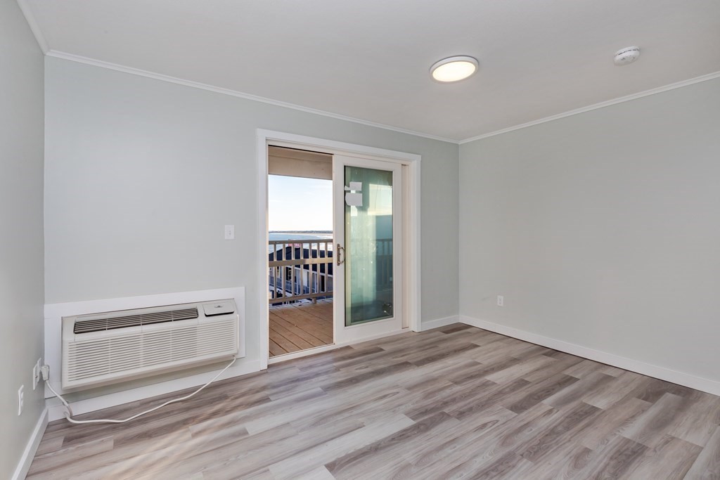 449 Ocean Boulevard, Unit 304 Hampton, NH 03842 - Photo 3 of 18 a view of wooden floor and windows in a room