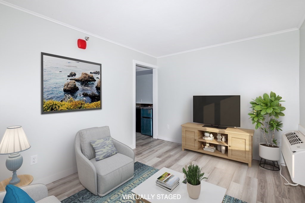 449 Ocean Boulevard, Unit 304 Hampton, NH 03842 - Photo 6 of 18 a living room with furniture and a flat screen tv