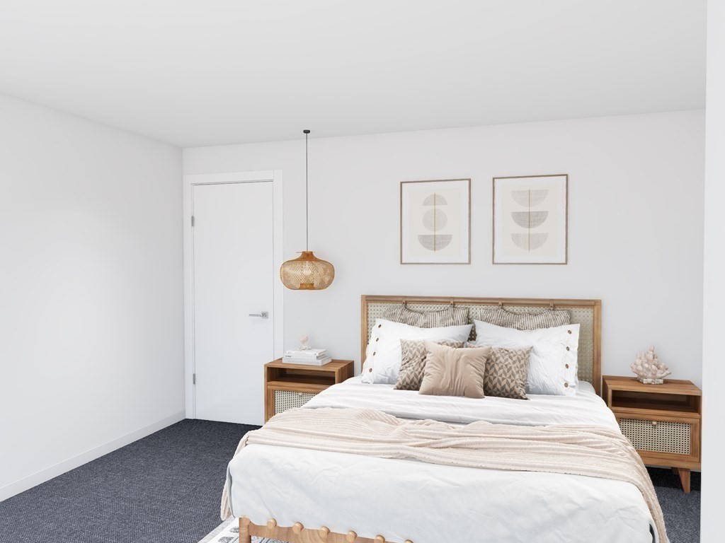 449 Ocean Boulevard, Unit 304 Hampton, NH 03842 - Photo 9 of 18 a bedroom with a bed and painting on the wall