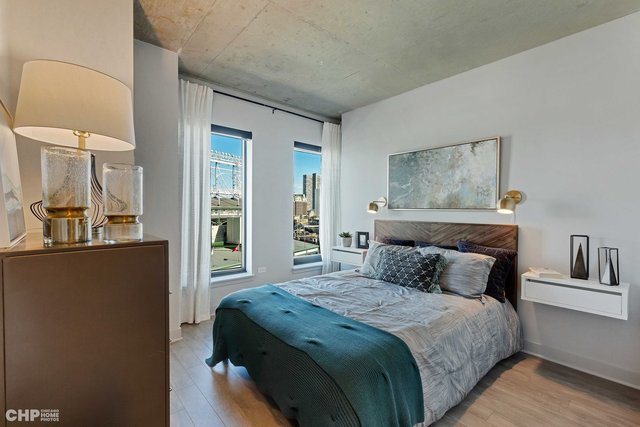 1025 West Addison Street, Unit 720 Chicago, IL 60613 - Photo 15 of 15 a bedroom with a bed and a painting on the wall