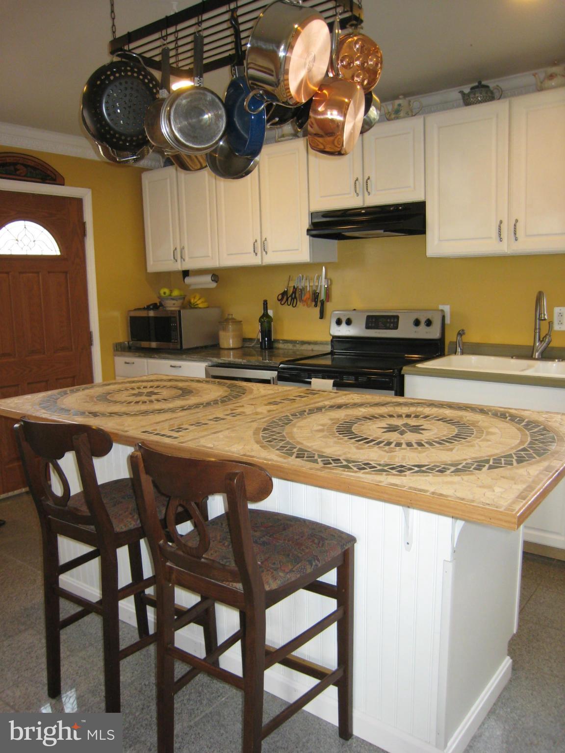2826 Ridge Road Baltimore, MD 21244 - Photo 13 of 30 a kitchen with stainless steel appliances granite countertop a stove a sink and a dining table