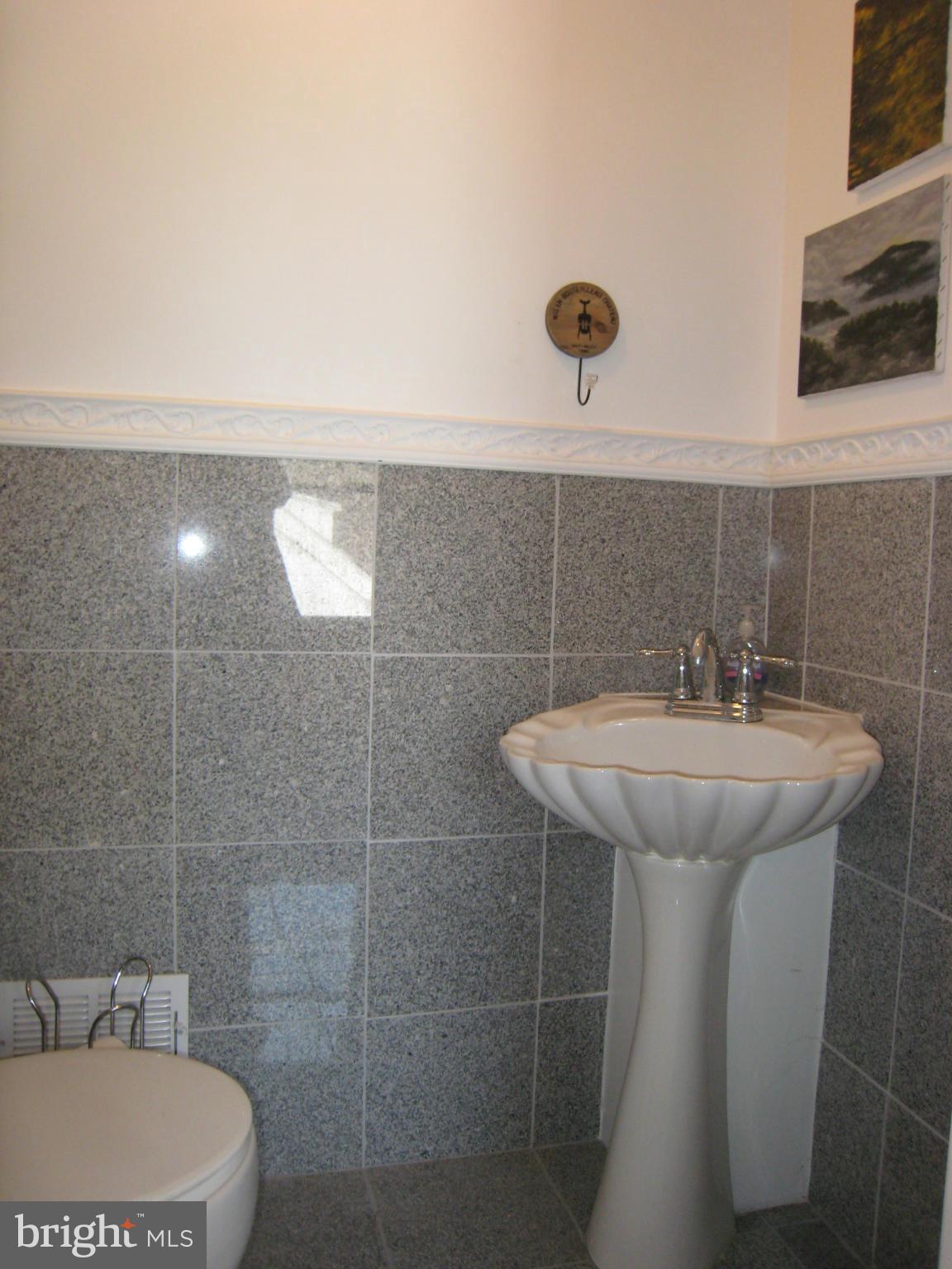 2826 Ridge Road Baltimore, MD 21244 - Photo 15 of 30 a bathroom with a sink a toilet and mirror