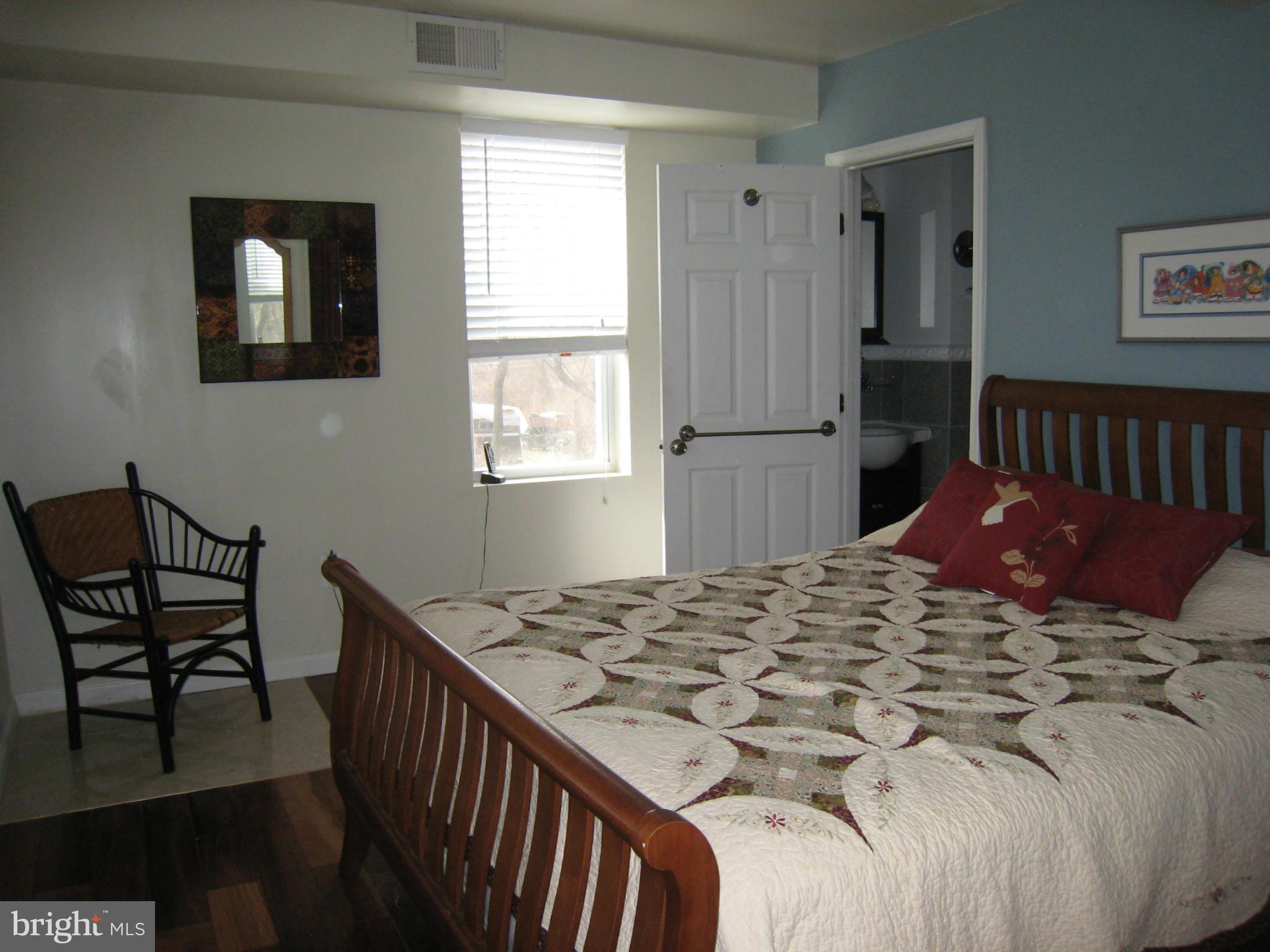 2826 Ridge Road Baltimore, MD 21244 - Photo 17 of 30 a bed sitting in a bedroom next to a window