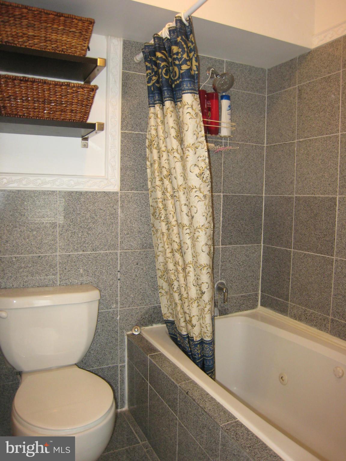 2826 Ridge Road Baltimore, MD 21244 - Photo 18 of 30 a bathroom with a toilet and shower
