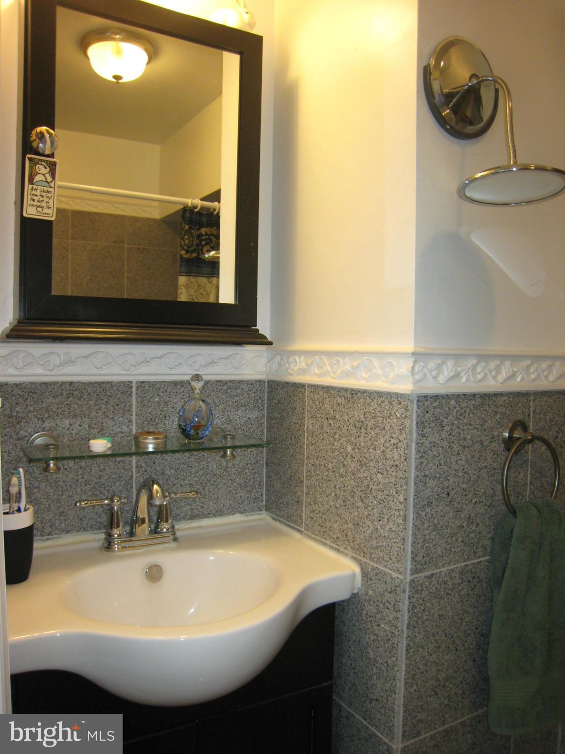 2826 Ridge Road Baltimore, MD 21244 - Photo 19 of 30 a bathroom with a sink and a mirror