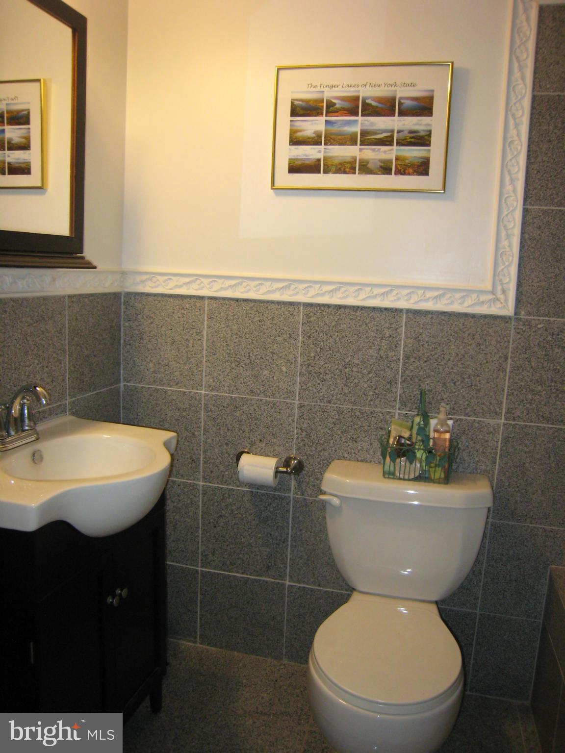 2826 Ridge Road Baltimore, MD 21244 - Photo 22 of 30 a bathroom with a toilet a sink and mirror