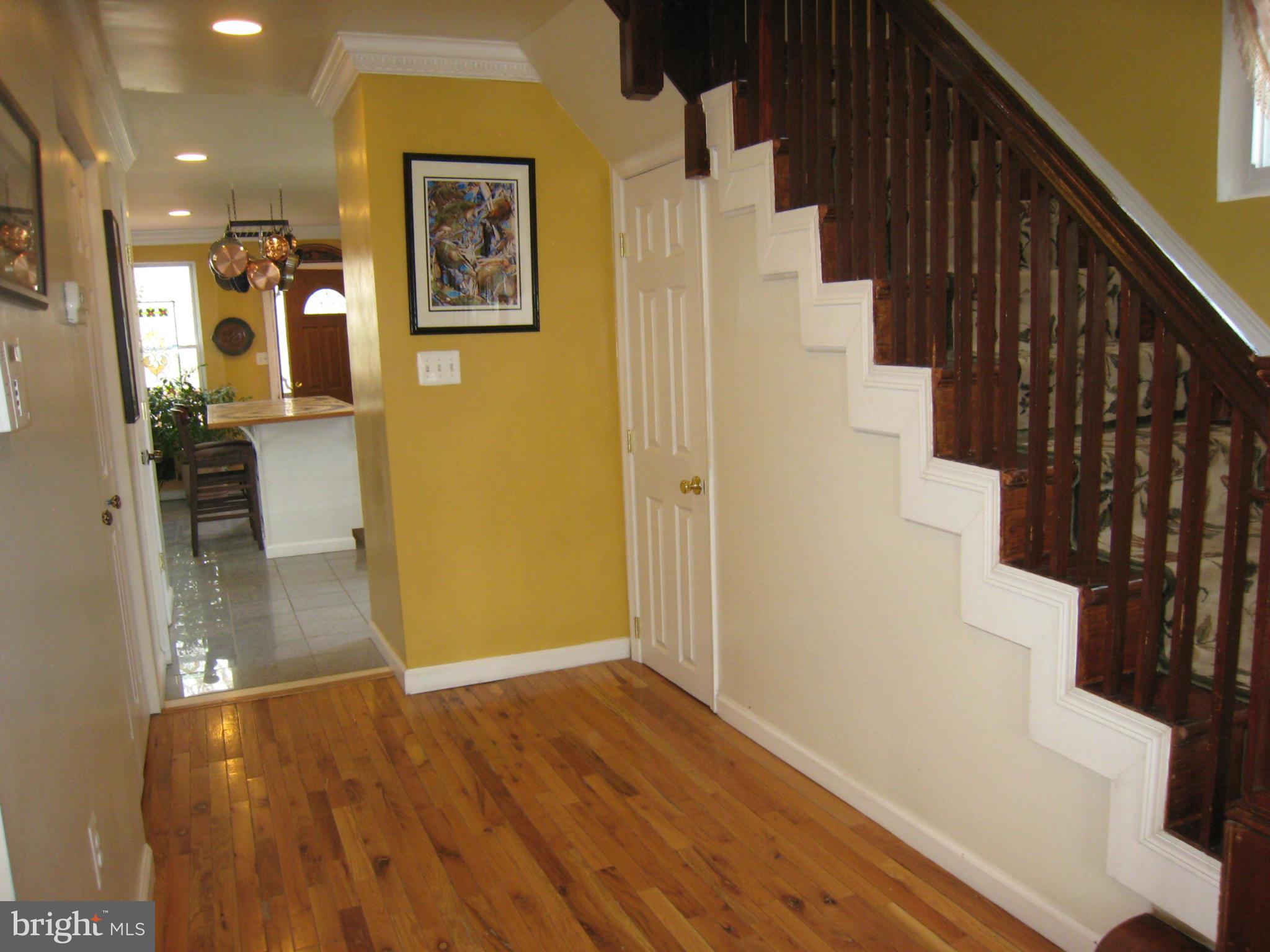 2826 Ridge Road Baltimore, MD 21244 - Photo 5 of 30 a view of a hallway with wooden floor and staircase