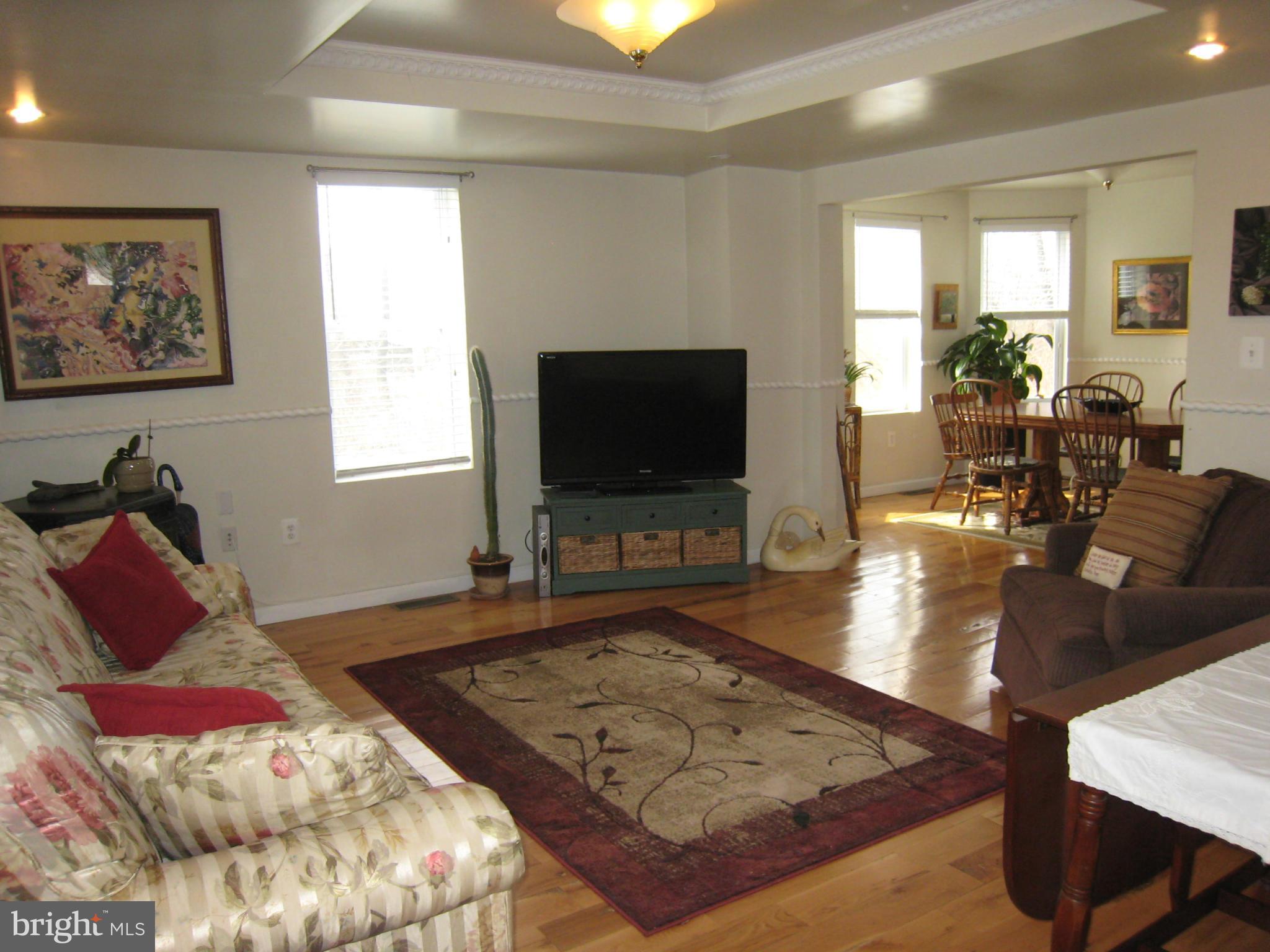 2826 Ridge Road Baltimore, MD 21244 - Photo 7 of 30 a living room with furniture and a flat screen tv