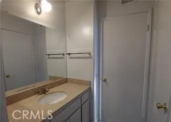 an empty room with a window and a ceiling fan